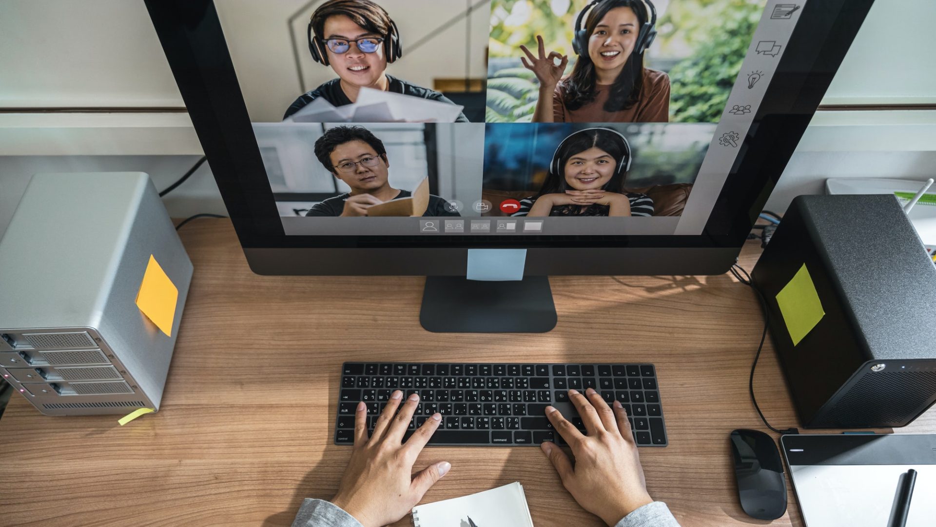 top-view-of-asian-business-man-hand-working-with-teamwork-colleague-in-video-conference.jpg